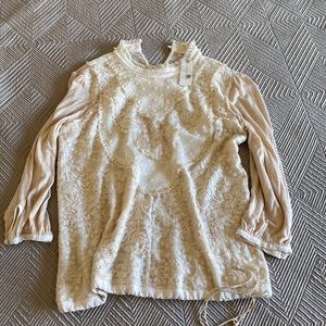 Beautiful blouse from Anthropologie, Brand is Tiny.
